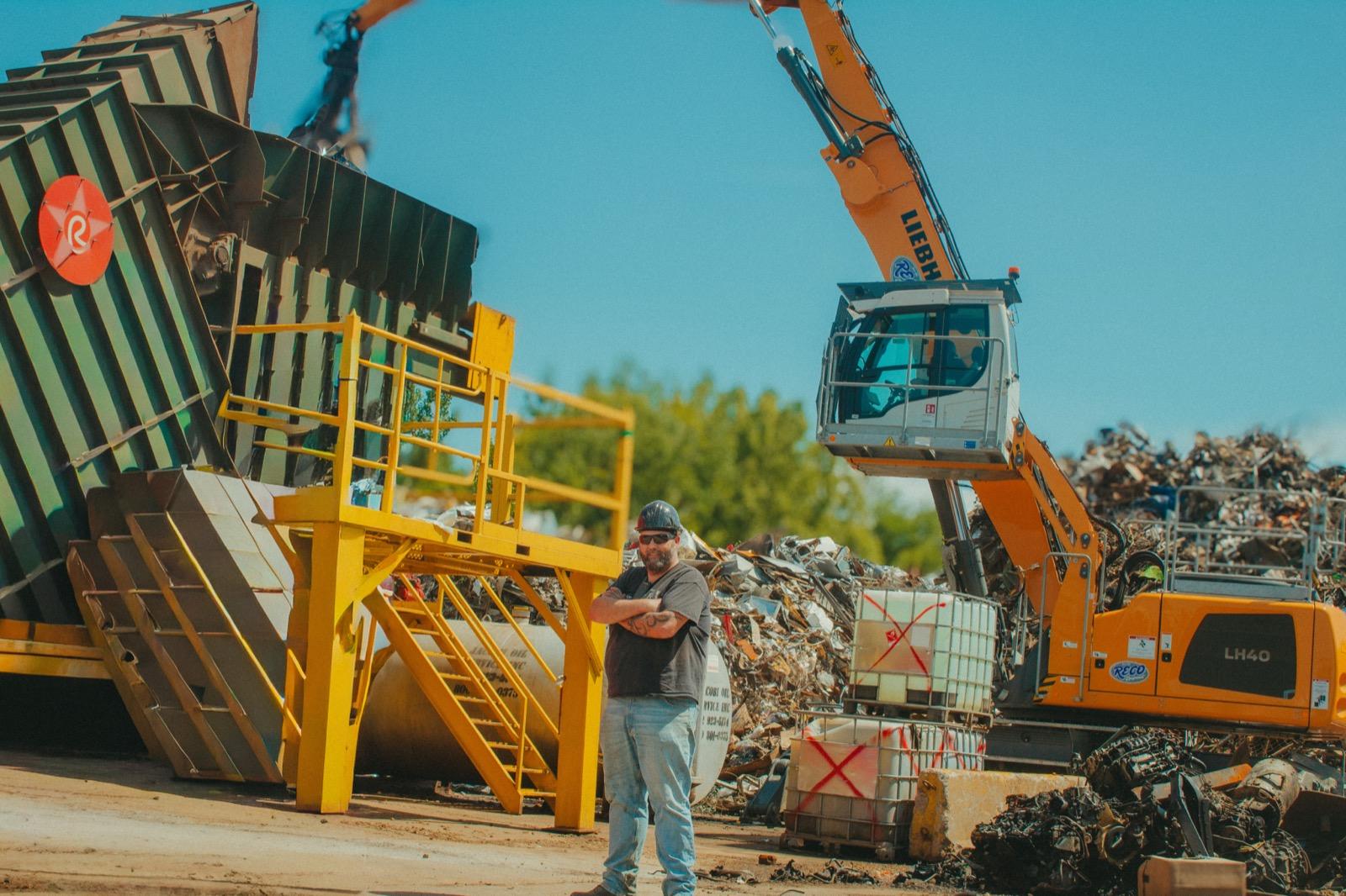 Red Ball Recycling team member at the yard with heavy machinery
